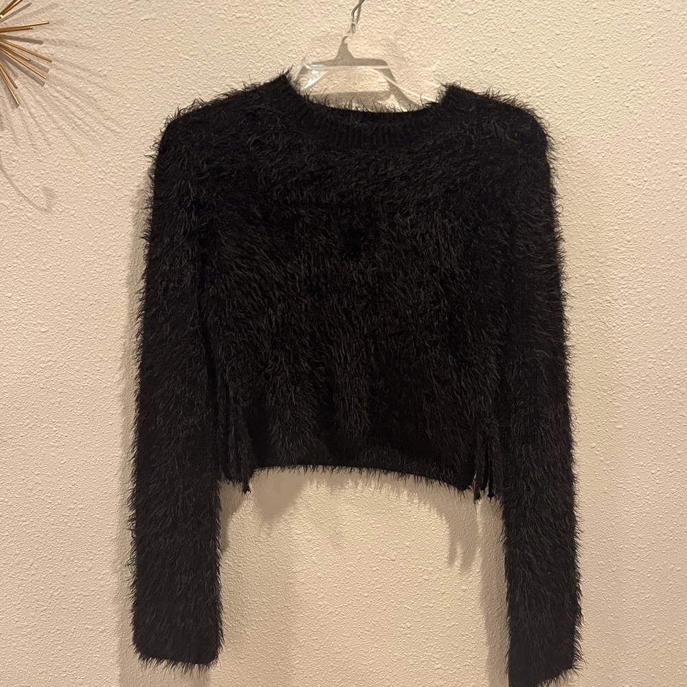 Selling this black fuzzy sweater with cut out sides that tie.